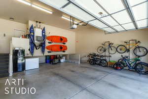Garage with freestanding refrigerator, a garage door opener, and refrigerator