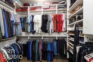 Walk in closet with carpet floors