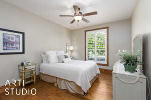 Bedroom with wood-type flooring and a ceiling fan