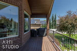 Wooden deck featuring a grill
