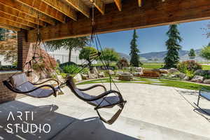 View of patio / terrace with an outdoor fire pit and a mountain view
