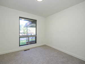 Carpeted empty room with baseboards