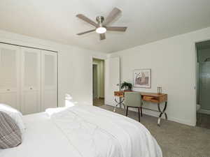Bedroom featuring a closet, carpet floors, connected bathroom, and a ceiling fan