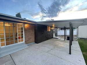 Patio terrace at dusk featuring entry steps