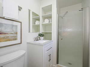 Full bathroom featuring a shower stall and vanity
