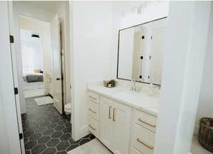 Ensuite bathroom featuring vanity and tile patterned floors