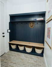 Mudroom with brick patterned flooring