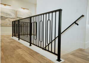 Stairs with wood finished floors and baseboards