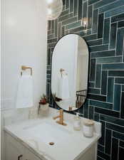 Bathroom featuring vanity and tile walls