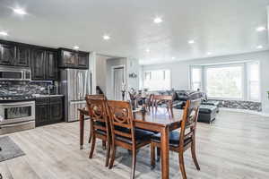 Dining room featuring light wood-style flooring and recessed lighting