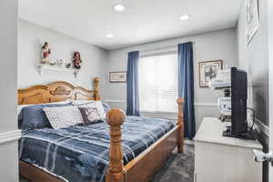 Carpeted bedroom featuring baseboards and recessed lighting