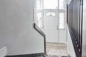 Entrance foyer with wood finished floors