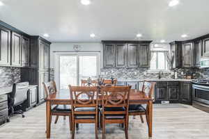 Dining room featuring light wood-style flooring, recessed lighting, and an office area