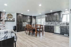 Dining room featuring light wood-style flooring and recessed lighting