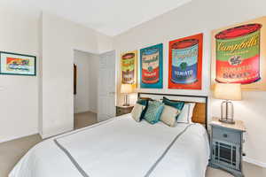 Bedroom with carpet floors and baseboards