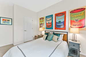 Carpeted bedroom featuring baseboards