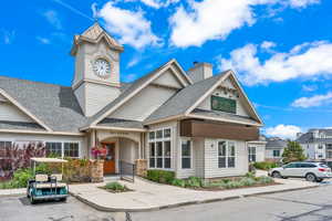 View of front of home with roof with shingles