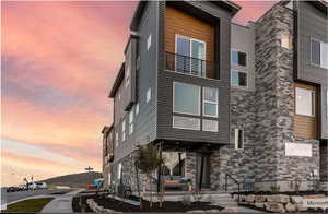 View of front of house with stone siding