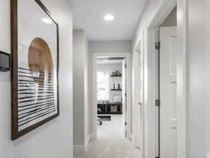 Hallway with carpet floors and baseboards