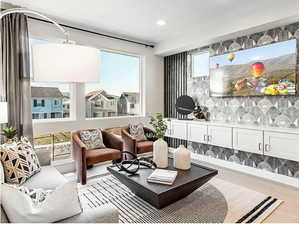 Living room with wood finished floors, recessed lighting, and bar