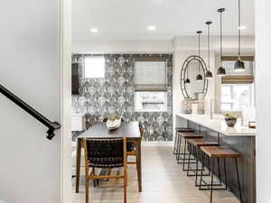Dining space with light wood finished floors, plenty of natural light, and recessed lighting