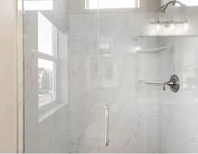 Bathroom with a marble finish shower