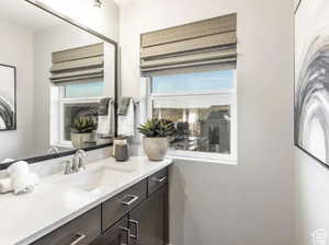 Bathroom featuring vanity and washer / dryer