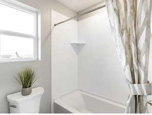 Full bath with toilet and shower / bath combo