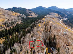 Aerial view of property's location featuring a mountainous background and property boundaries highlighted