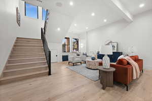 Living area featuring stairs, light wood-type flooring, and recessed lighting
