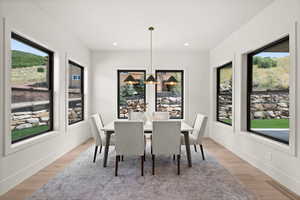 Dining space featuring a chandelier, light wood-style floors, and recessed lighting