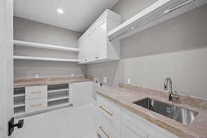 Washroom featuring hookup for a washing machine, electric dryer hookup, cabinet space, and recessed lighting