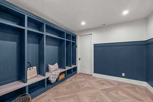 Mudroom featuring a wainscoted wall and recessed lighting