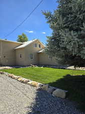 View of side of home with a lawn