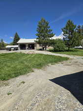 View of front facade with driveway and a front lawn