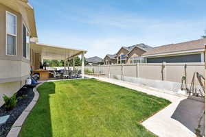 Fenced backyard featuring a patio and outdoor lounge area