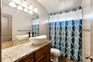 Bathroom featuring vanity, curtained shower, and tile patterned flooring