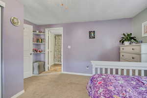 Bedroom featuring carpet floors and baseboards