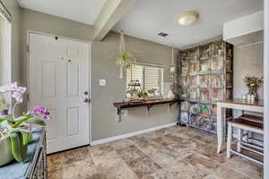 Foyer entrance with baseboards