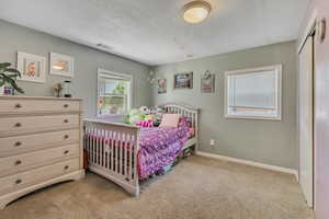 Bedroom featuring carpet floors and baseboards
