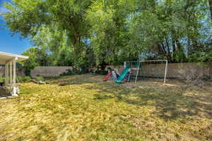 Fenced backyard with a playground