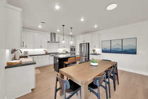 Dining space with light wood-style flooring and recessed lighting
