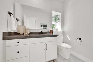 Bathroom featuring vanity and toilet