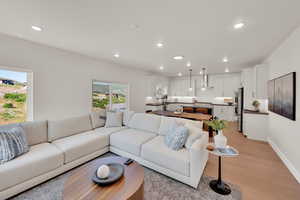 Living room with recessed lighting and light wood-style flooring