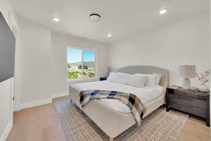 Bedroom with light wood-style floors and recessed lighting
