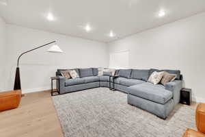 Living room featuring light wood-style floors and recessed lighting