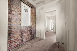 Hall featuring brick wall