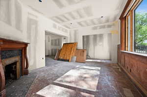 Unfurnished living room featuring a tile fireplace
