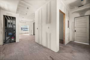 Corridor with hardwood / wood-style floors