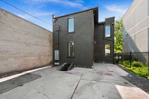 Back of house featuring brick siding and a patio